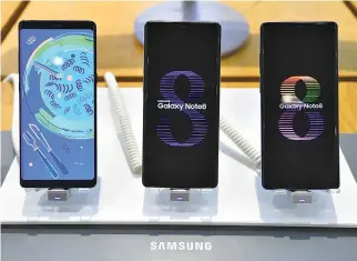  ??  ?? SAMSUNG GALAXY NOTE 8 smartphone­s are displayed at the company’s showroom in Seoul on Jan. 31. Samsung Electronic­s reported a 73% jump in its fourth-quarter net profit on Jan. 31, setting a record for any three-month period, mainly driven by demand for...