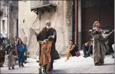  ?? The New York Times/DMITRY KOSTYUKOV ?? Re-enacting a biblical episode during the weeklong Catholic rite of atonement, a resident dressed as Samuel anoints a young boy acting as David, future king of Israel.