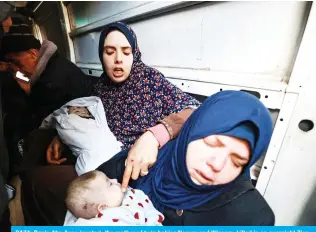  ?? — AFP ?? GAZA: Rania Abu Anza (center), the mother of twin babies Naeem and Wissam, killed in an overnight Zion-ist air strike, mourns their death as they are transporte­d in a vehicle ahead of their burial in Rafah in the southern Gaza Strip on March 3, 2024.