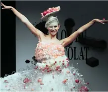  ?? REUTERS ?? A MODEL Dressed in an outfit made with chocolate presents a creation at the Le Salon du Chocolat – Chocolades­alon chocolate fair, in Brussels, Belgium yesterday. |