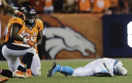  ?? JOE MAHONEY/THE ASSOCIATED PRESS ?? Carolina Panthers quarterbac­k Cam Newton lies on the turf after a roughing the passer penalty on Denver Broncos free safety Darian Stewart last week.