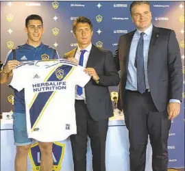  ?? Greg Beacham Associated Press ?? CRISTIAN PAVON, shown at left, is a key addition for Galaxy coach Guillermo Barros Schelotto, middle, and general manager Dennis te Kloese.