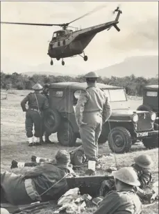  ??  ?? Soldiers watch a SAAF helicopter taking off from a field near Langa in 1960. The government deployed troops and police on a massive scale as protests spread across the country after the Sharpevill­e massacre.