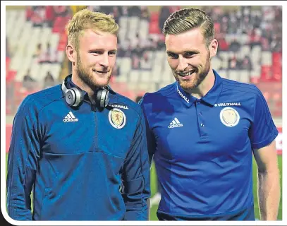  ??  ?? Scott Bain on Scotland duty in Lima alongside Stephen O’Donnell and, (right) enjoying a chest bump with Celtic skipper Scott Brown on his Old Firm debut