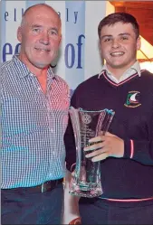  ??  ?? Mark Nicholson accepts the Young Person of the Year Award from Joe Healy.