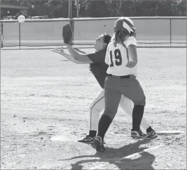  ??  ?? Rossville's first baseman Jada Smith stretches to try and get the putout against Saddle Ridge runner Abby Sansing during a game at Rossville City Park last week. (Messenger photo/Scott Herpst) Saddle Ridge 10, Rossville 1 LaFayette 12, Rossville 1...