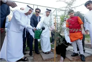  ?? Photos by Dhes Handumon ?? Thani bin Ahmed Al Zeyoudi and Dr Abdulla Al Karam water a sapling during the inaugurati­on of the Forest Bathing Corridor at the Indian High School, Dubai, on Monday. —