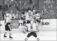  ?? CAIRNS/DISPATCH] [ADAM ?? The Penguins’ Sidney Crosby, center, celebrates with teammates after an overtime goal from Jake Guentzel.