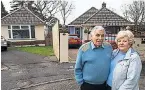  ??  ?? Peter and Sally Lane outside their bungalow in Poole with the dividing pillar