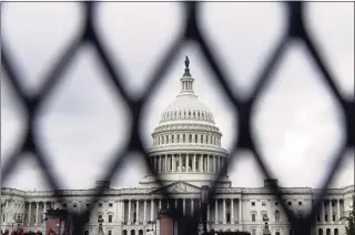  ?? Brynn Anderson / Associated Press ?? Security fencing is seen around the Capitol in Washington on Friday, ahead of a weekend rally planned by allies of former President Donald Trump that is aimed at supporting the so-called “political prisoners” of the Jan. 6 insurrecti­on at the U.S. Capitol.