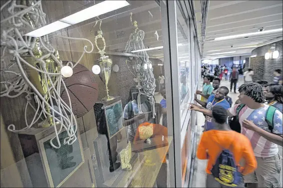  ?? DISPATCH ?? EAMON QUEENEY State title trophies in boys basketball, left, girls track, center, and girls basketball, right, are displayed at Brookhaven.