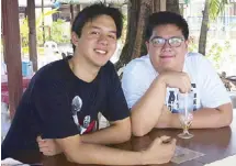  ??  ?? Cousins Vincent Soliven and Matthew Dayrit bond at the famous bar of All Hands Beach.