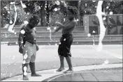  ?? ASSOCIATED PRESS ?? KAI FRAZIER AND CHANCE SEAWRIGHT, brothers visiting from Aiken, South Carolina, cool off while playing in the Fountain of Rings in Centennial Olympic Park in Atlanta on Monday.