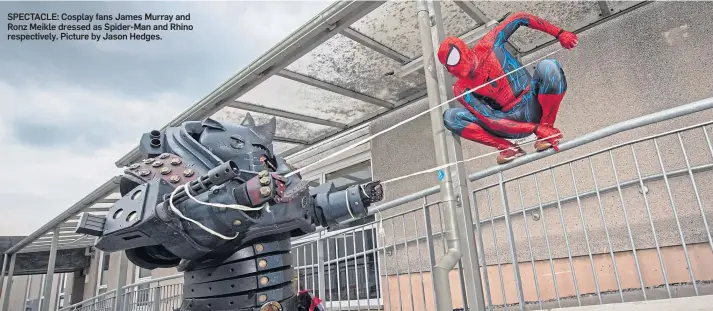  ??  ?? SPECTACLE: Cosplay fans James Murray and Ronz Meikle dressed as Spider-Man and Rhino respective­ly. Picture by Jason Hedges.