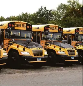  ?? Ned Gerard / Hearst Connecticu­t Media ?? School buses in a Connecticu­t town.