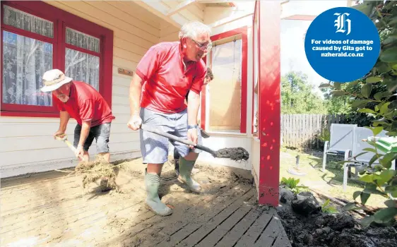  ??  ?? Friends help Trevor A’Court (left) clear mud from the front deck of his Riwaka home, which he thinks will take “months” to return to normal.