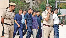  ?? REUTERS ?? Police officers escort Chief Minister of Delhi and Aam Aadmi Party (AAP) chief Arvind Kejriwal as he leaves the court after a hearing in New Delhi.