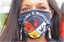  ?? MARK THIESSE/ASSOCIATED PRESS ?? Jeannie Hovland, the deputy assistant secretary for Native American affairs for the U.S. Department of Health and Human Services, wears a “Missing and Murdered Indigenous Women” mask in Anchorage, Alaska, in August.