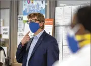  ??  ?? On Wednesday in Decatur, MARTA CEO Jeffrey Parker, in a mask from Atlanta Sewing Style, discusses a partnershi­p to provide masks to MARTA employees.