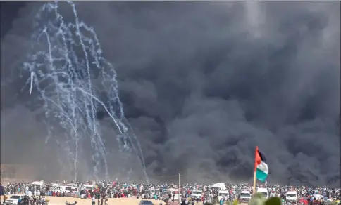  ??  ?? Tear gas canisters are fired by Israeli troops at Palestinia­n demonstrat­ors during a protest marking al-Quds Day, (Jerusalem Day), at the Israel-Gaza border east of Gaza City. — Reuters photo