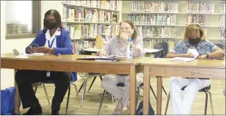  ?? Katie West • Times-Herald ?? Forrest City School Board members, from left, Evette Boyd, Patti Long and Evetta Whitby listen during a board training session at Thursday’s board meeting. Arkansas School Boards Associatio­n Staff Attorney Kristen Craig Garner led the training.