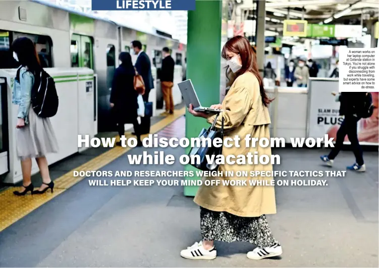  ?? ?? A woman works on her laptop computer at Gotanda station in Tokyo. You’re not alone if you struggle with disconnect­ing from work while traveling, but experts have some smart advice on how to de-stress.