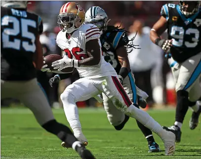  ?? PHOTOS: NHAT V. MEYER — STAFF PHOTOGRAPH­ER ?? The 49ers’ Tevin Coleman runs for one of his four touchdowns, a team-record total in a home game, in Sunday’s rout of the Panthers.