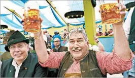  ??  ?? At Oktoberfes­t, Bavarians are happy to toast with friendly foreigners.
