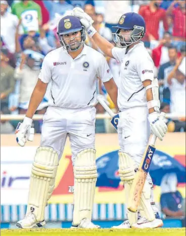  ?? PTI ?? ■ Ajinkya Rahane congratula­tes Rohit Sharma during the first day of the third Test against South Africa in Ranchi on Saturday.
