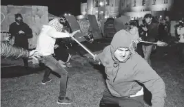  ?? WALLY SKALIJ Los Angeles Times/tns ?? A pro-palestinia­n protester clashes with a pro-israeli supporter at an encampment at UCLA on May 1.