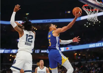  ?? Tribune News Service/bay Area News Group ?? Golden State Warriors’ Jordan Poole (3) takes a shot against Memphis Grizzlies’ Ja Morant (12) in the second quarter of Game One of the secondroun­d playoff series at the Fedex Forum in Memphis, Tennessee, on Sunday.