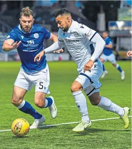  ??  ?? Kane Hemmings drives at Queen of the South defender Darren Brownlie. Picture: SNS Group.