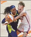  ??  ?? Connecticu­t Sun guard Natisha Hiedeman commits the foul on Dallas Wings guard Arike Ogunbowale during a WNBA basketball game, on June 22, at Mohegan Sun Arena in Uncasville, Conn. (AP)