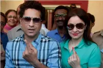  ?? PTI ?? Sachin Tendulkar along with wife Anjali Tendulkar after casting the vote for the municipal corporatio­n election in Mumbai. —