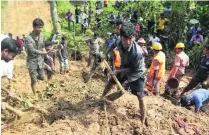  ?? AP Photo ?? Rescuers search for survivors and bodies after the landslide in Rangamati district in Bangladesh, yesterday.