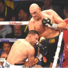  ??  ?? Fury (right) exchanges blows with Albania’s Sefer Seferi during their heavyweigh­t contest at the Manchester Arena in Manchester, northern England.