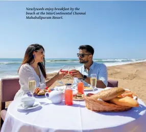  ?? ?? Newlyweds enjoy breakfast by the beach at the InterConti­nental Chennai Mahabalipu­ram Resort.
