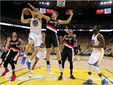  ?? — AFP ?? Golden State Warriors’ Zaza Pachulia (second from left) goes up for a shot against Portland Trail Blazers’ Meyers Leonard on Wednesday.