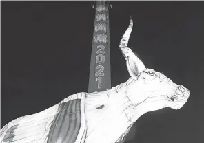  ?? ALASTAIR GRANT/ AP ?? A Year of the Ox illuminati­on lights up Nelson’s Column In Trafalgar Square in London with the words “Happy New Year” on Wednesday.