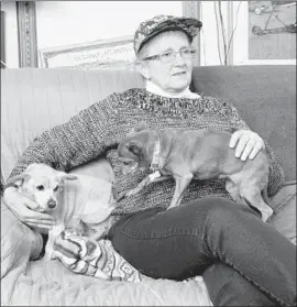  ?? Charlie Neuman San Diego Union-Tribune ?? LAURA JOHNSTON KOHL, with dogs Roxy and Lilly, says her life with the Peoples Temple “is part of my core. I somehow survived. I can’t waste my life now.”