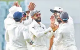  ?? AFP ?? Indian players celebrate the wicket of Australian Peter Handscomb on Day 4 of the first Test at the Adelaide Oval on Sunday. &gt;&gt; P16