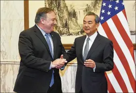  ?? DAISUKE SUZUKI / POOL / KYODO ?? Chinese Foreign Minister Wang Yi (right) greets U.S. Secretary of State Mike Pompeo prior to a meeting at the Diaoyutai State Guesthouse on Monday in Beijing. Wang was unusually sharp during an appearance with Pompeo.