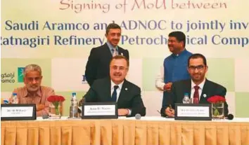  ??  ?? WAM Shaikh Abdullah and India’s Petroleum and Natural Gas Minister Dharmendra Pradhan look on as Saudi Aramco CEO Amin H. Nasser (centre) and chairman of the board of directors of Abu Dhabi Ports Sultan Ahmad Al Jaber (right) sign the MoU in New Delhi...