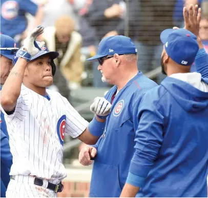  ??  ?? Addison Russell ( left) ripped monster home runs Monday and Tuesday. On Thursday, he hit in the cleanup spot. | GETTY IMAGES