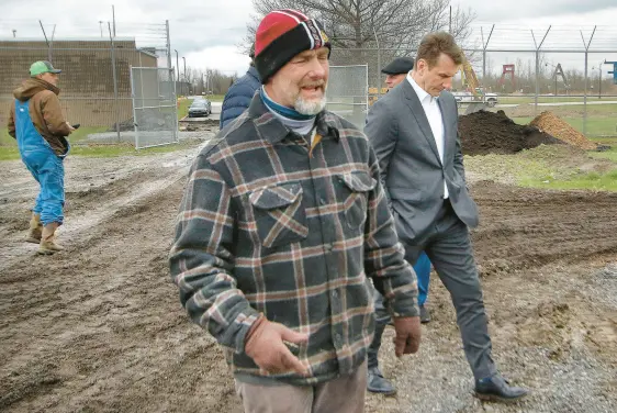  ?? JOHN SMIERCIAK/POST-TRIBUNE PHOTOS ?? Lake County Juvenile Court Senior Judge Thomas Stefaniak Jr., center, leads U.S. Rep. Frank Mrvan, D-Highland, right, on a tour of the Lake County Juvenile Justice Center’s farm area that is being expanded with a vertical garden on April 5.