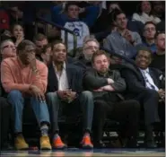  ?? CRAIG RUTTLE — THE ASSOCIATED PRESS ?? Madison Square Garden chairman James Dolan, center left, sits with former New York Knicks team members and others as he watched the Knicks take on the San Antonio Spurs during an NBA game at Madison Square Garden in New York on Feb. 12.