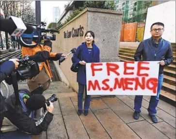  ?? Jonathan Hayward Associated Press ?? PEOPLE PROTEST Monday at a courthouse in Vancouver, Canada. Huawei Technologi­es Co. CFO Meng Wanzhou is accused of guiding the Chinese firm’s effort to mask violations of sanctions on sales to Iran.