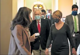  ?? ANNA MONEYMAKER / NYTNS ?? Senate Majority Leader Mitch McConnell, R-Ky., walks with reporters and staff to his office at the Capitol in Washington on Friday after participat­ing in a voice vote to approve a oneweek stopgap bill to fund the government.