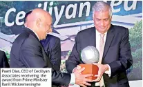  ??  ?? Paani Dias, CEO of Ceciliyan Associates receiveing the award from Prime Minister Ranil Wickremesi­nghe