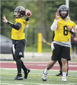  ?? PETER POWER/THE CANADIAN PRESS ?? Even though Johnny Manziel, left, is a threat to his job, incumbent Ticats quarterbac­k Jeremiah Masoli has been helping the former Heisman Trophy winner adjust to the CFL.
